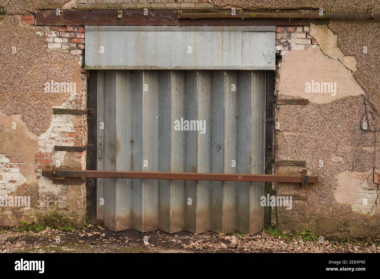 Old style shutter on an abandoned warehouse Stock Photo