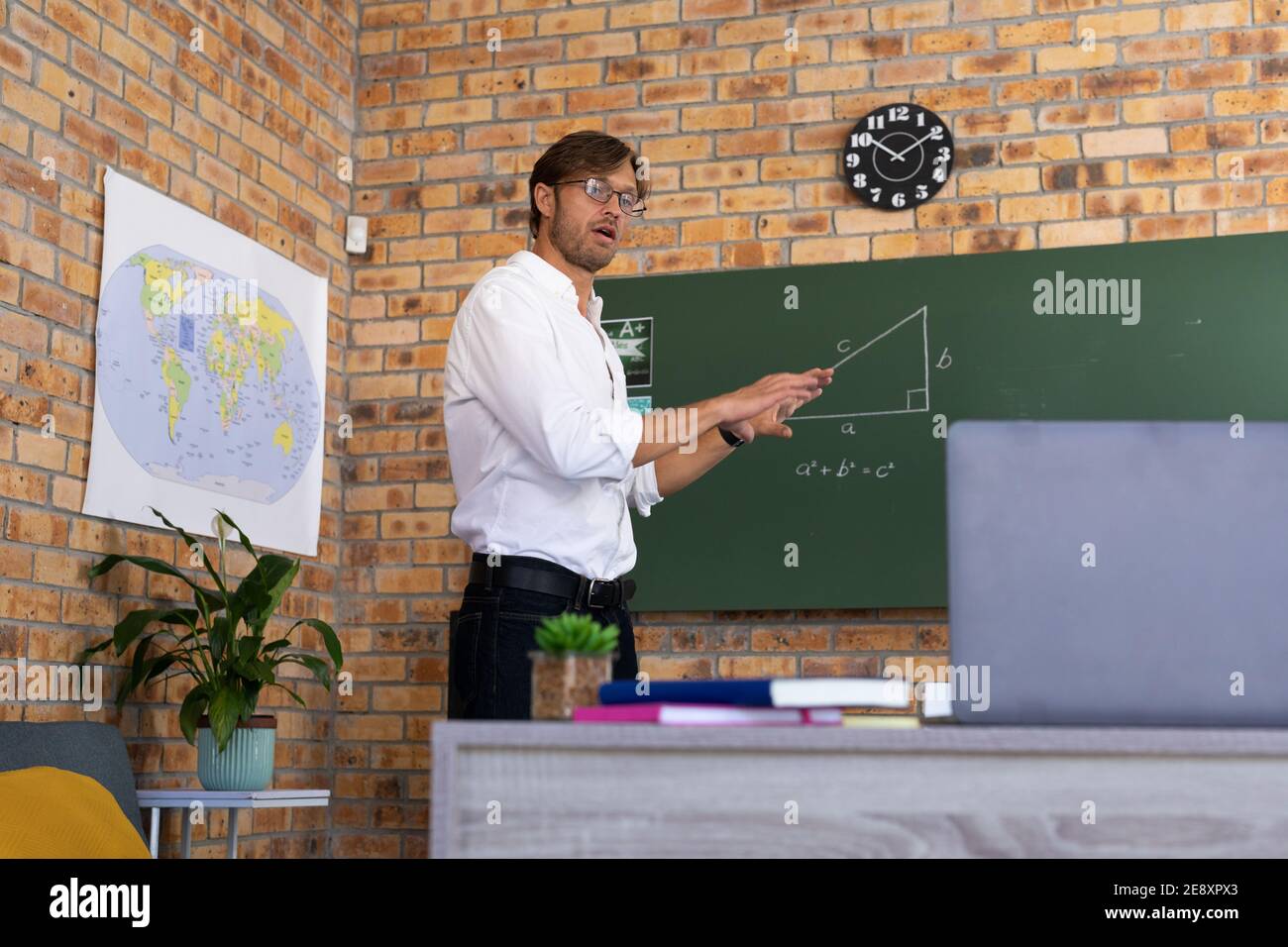 Man Teaching Math Male teacher standing by blackboard hi-res stock photography and images ...