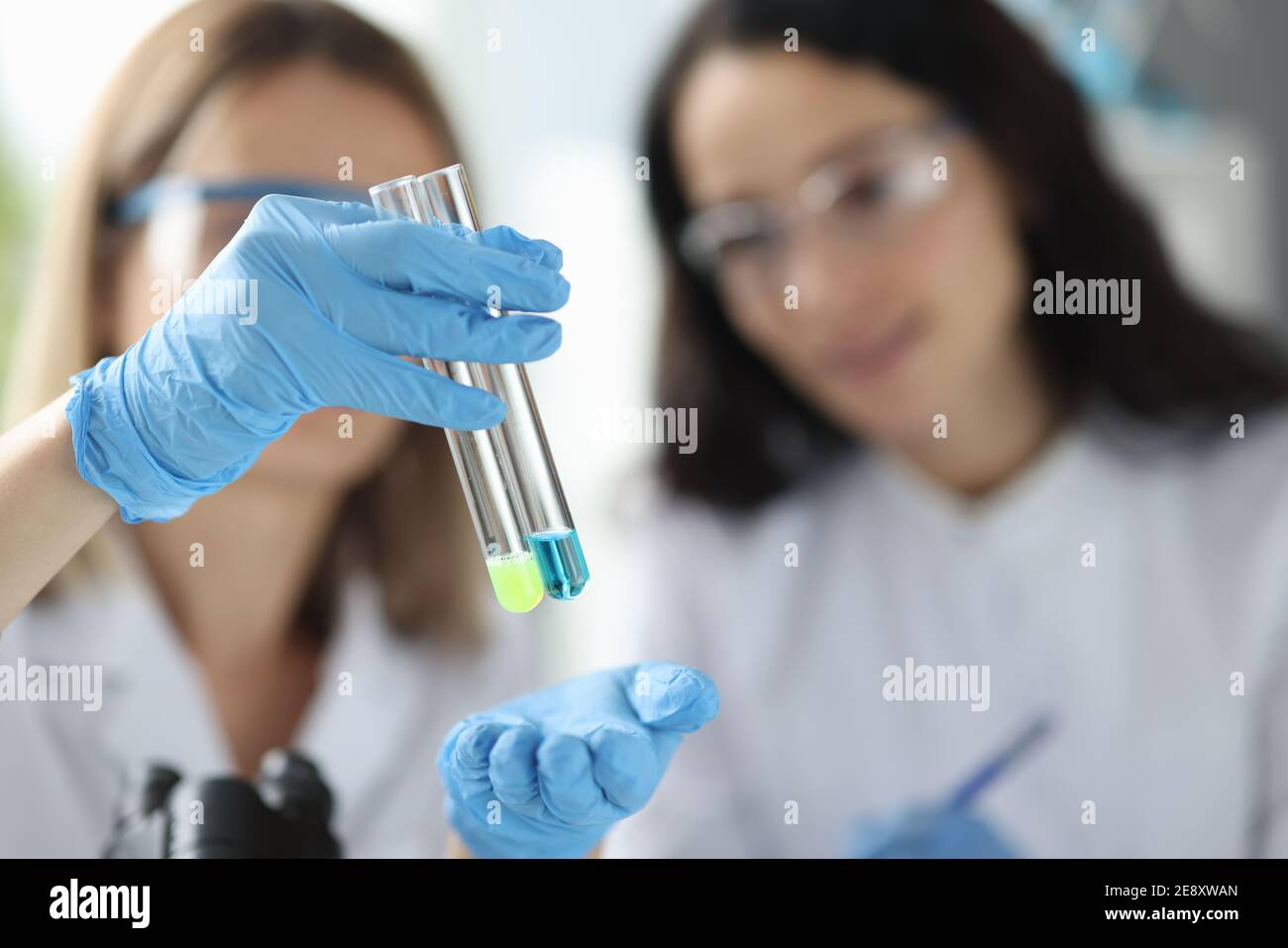 Women scientists holding test tubes with liquid in laboratory Stock ...