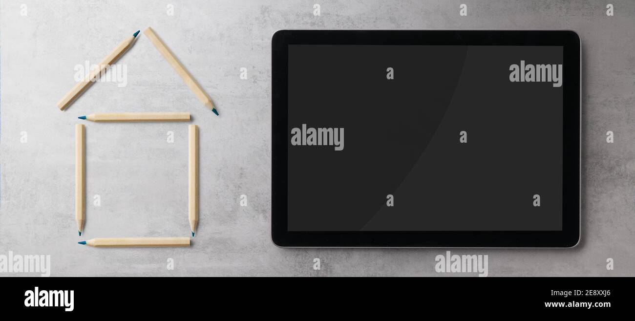 Flat lay top view of tablet and outline of house, housing concept. Copy space. Stock Photo