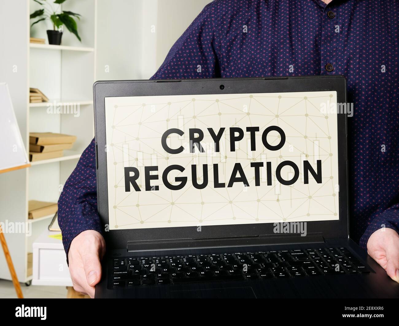 Man shows laptop with crypto regulation rules. Stock Photo