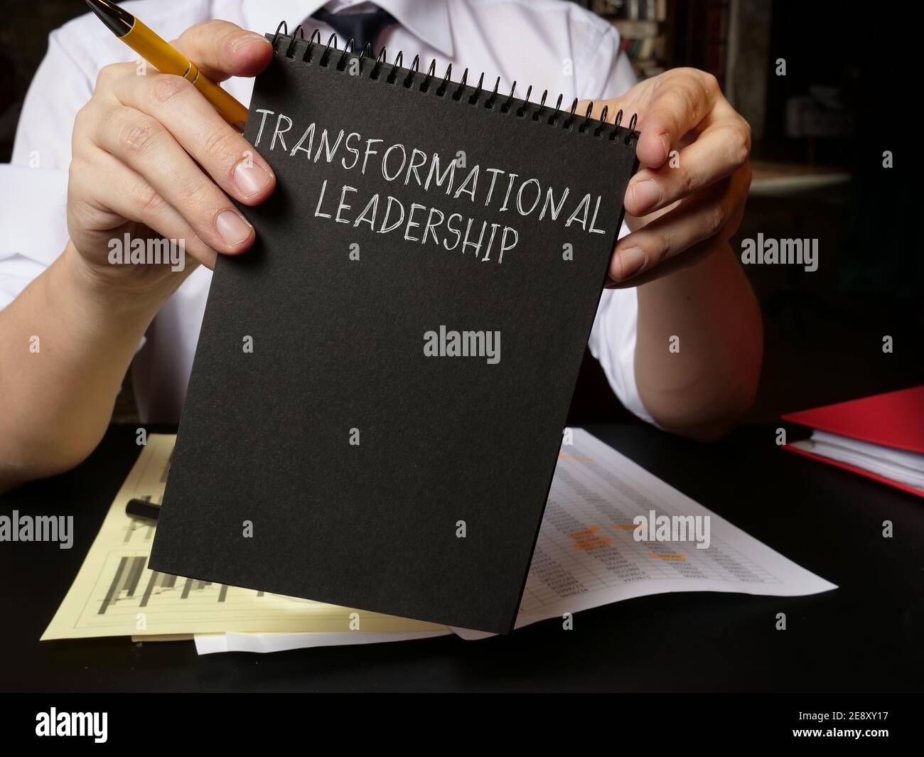 Manager holds info about Transformational leadership. Stock Photo