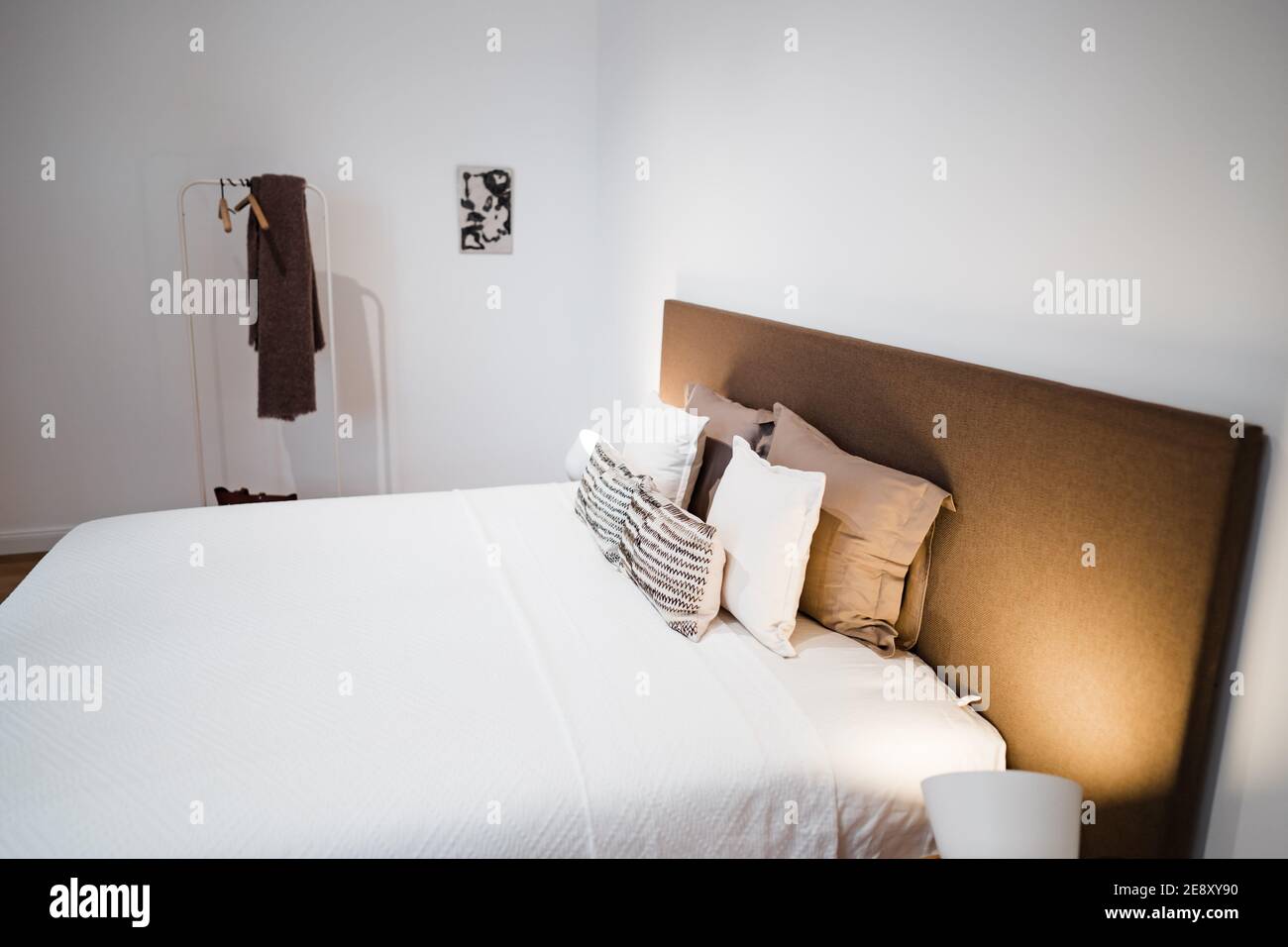 a bed in a simple modern bedroom at night Stock Photo - Alamy