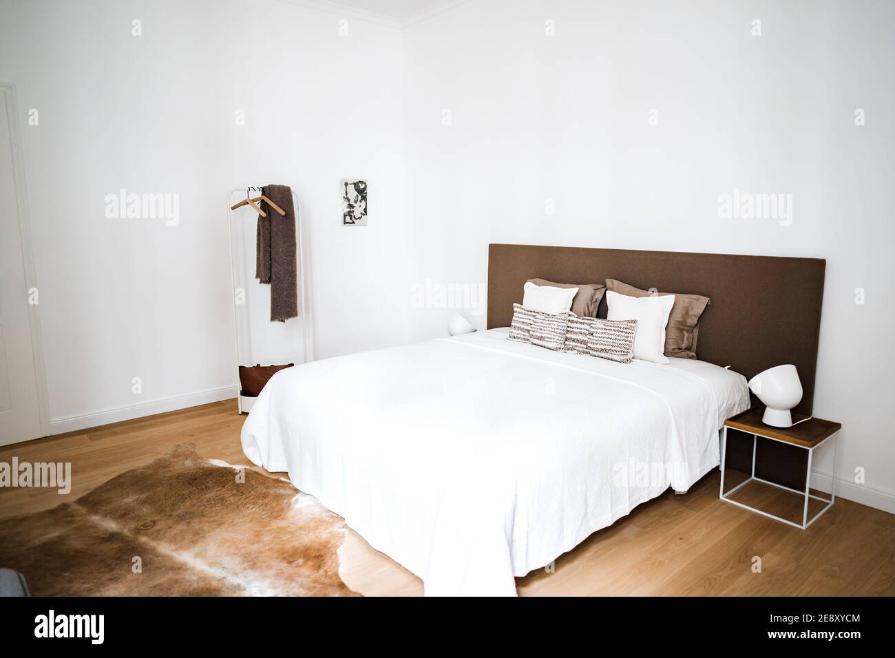 a bed in a simple modern bedroom at night Stock Photo - Alamy