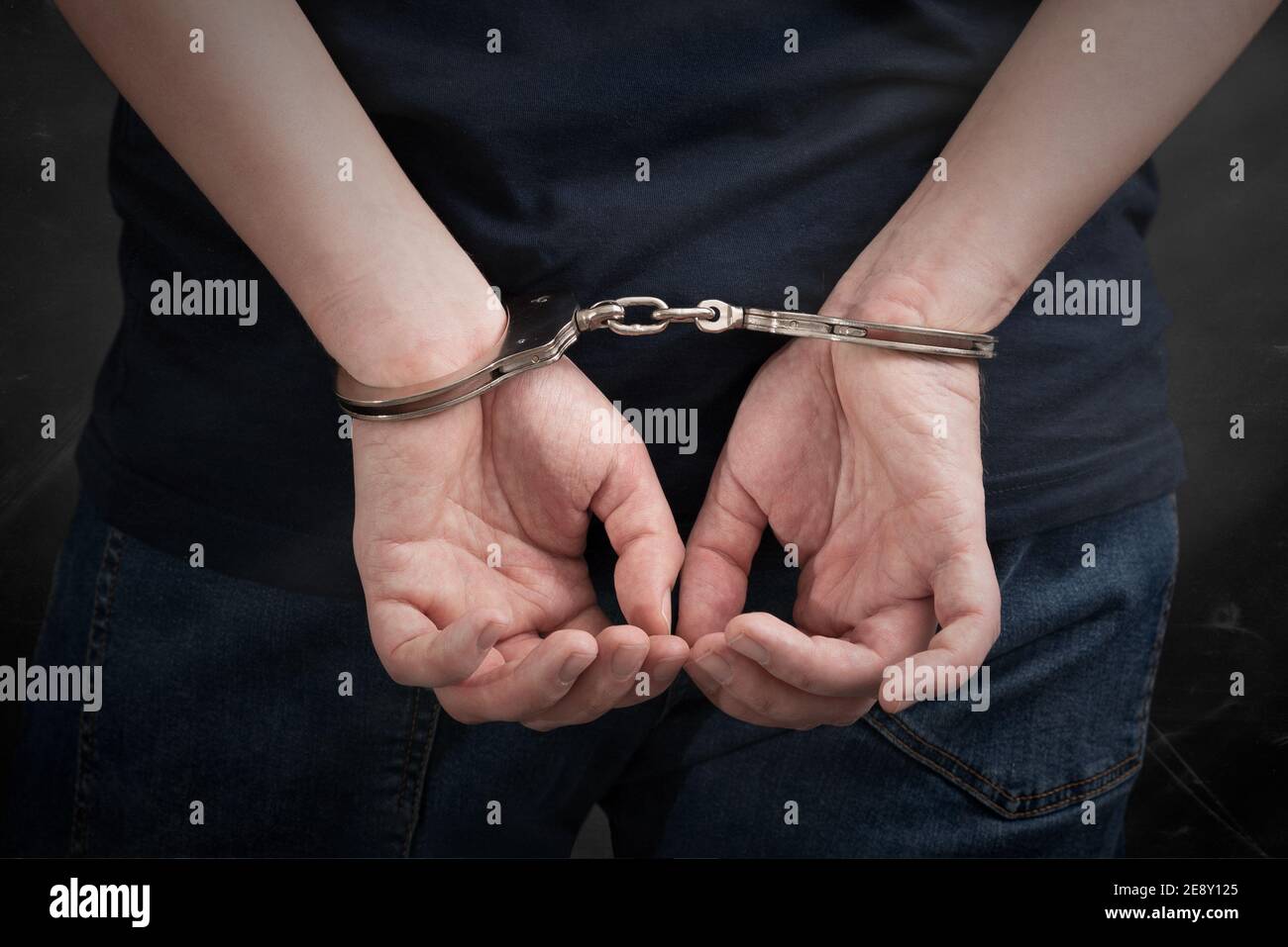 Criminal handcuffed, back view. Criminal arrested, security concept Stock Photo