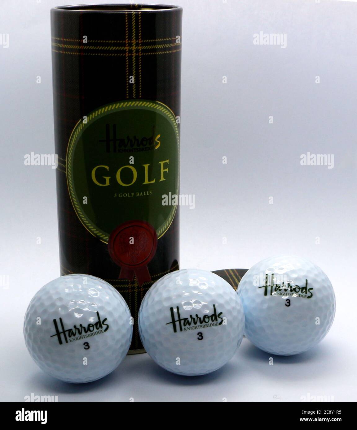 Photo of an Open tin tube gift with three golf balls from Harrods shop
