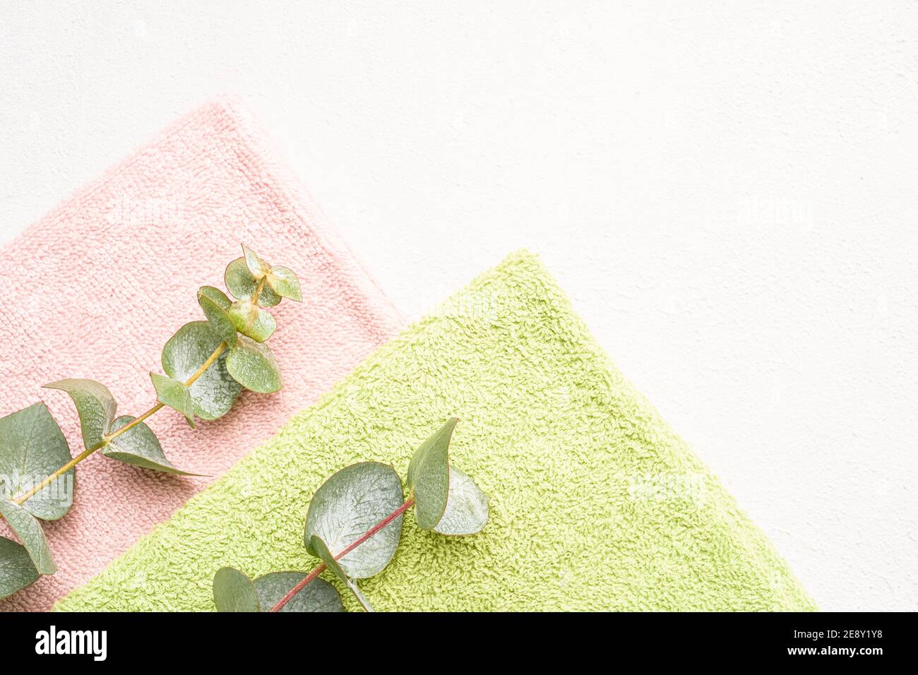 https://c8.alamy.com/comp/2E8Y1Y8/rolled-towels-and-green-eucalyptus-branches-on-white-concrete-background-minimalist-scandinavian-style-spa-hygiene-wellness-well-being-body-care-2E8Y1Y8.jpg