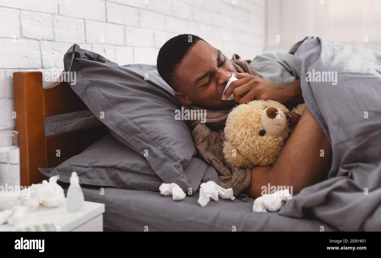 Sick African Man Coughing Suffering From Pneumonia In Bed Indoor Stock Photo