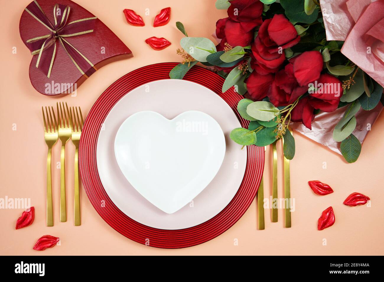 St Valentine's Day dinner table setting with red roses, heart shape ...