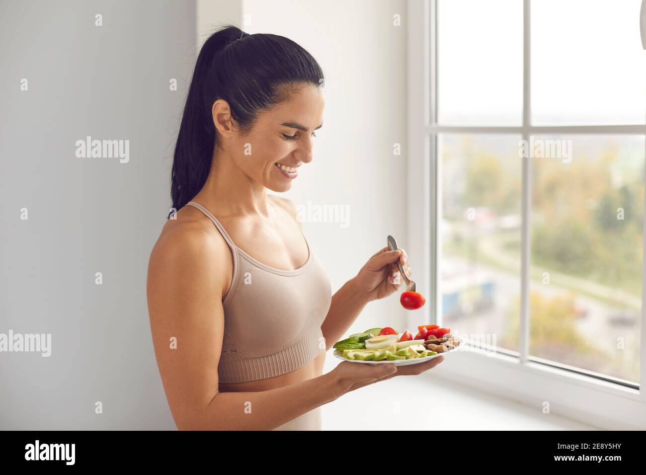 Fitness woman eating balanced healthy meal before or after workout Stock Photo