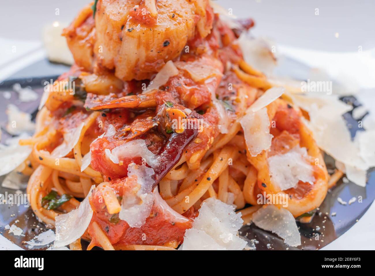 Spaghetti with prawns, sea scallops and parmesan Stock Photo
