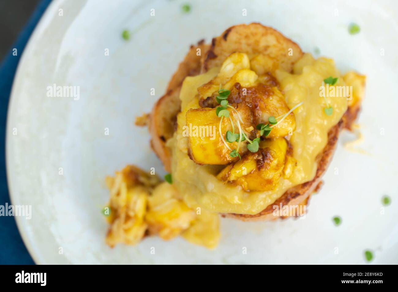 Vegan french toasts with peanut butter, syrup and banana on a white plate. Stock Photo