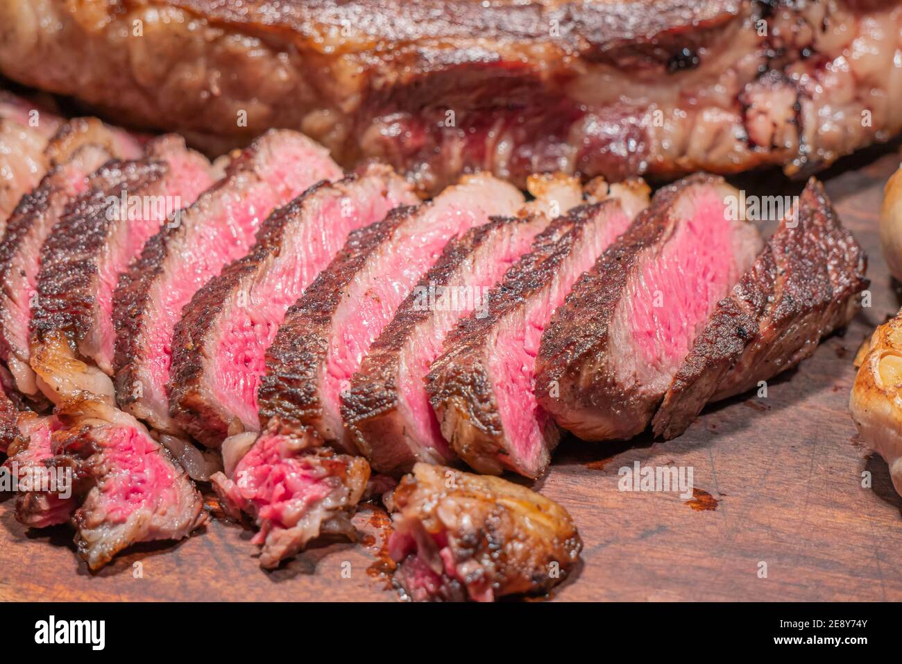 Dry-aged marble beef steak Tomahawk on wooden board with spices. Close-up, dinner concept. Stock Photo