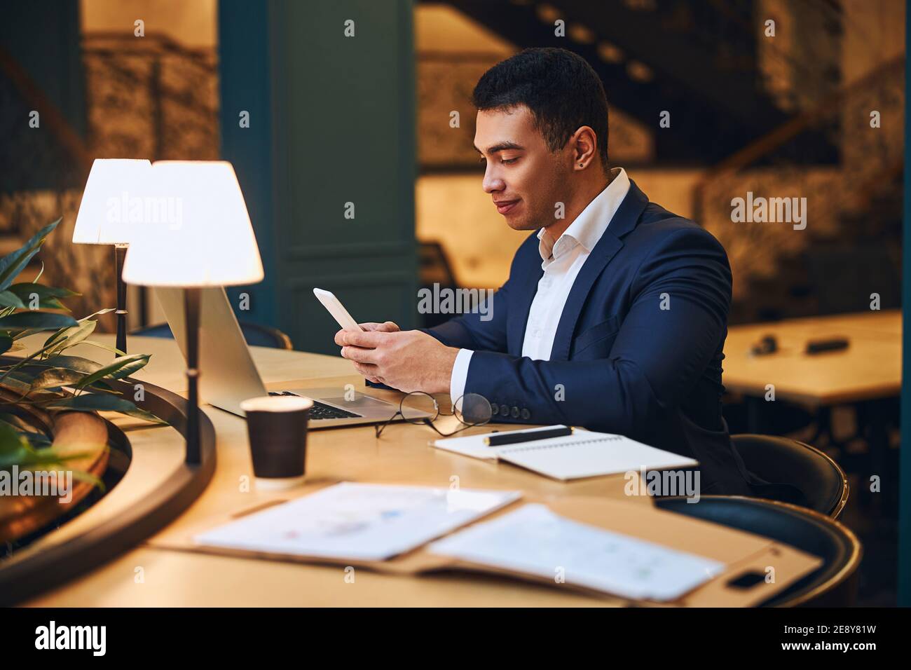 Concentrated Latin American man writing a text message Stock Photo