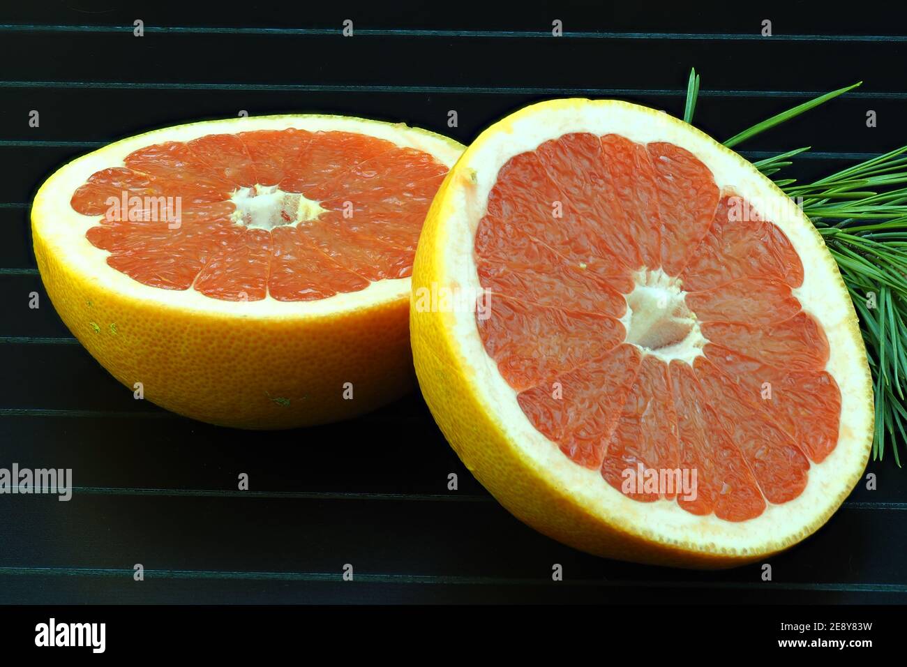 Grapefruit, cut on a black background, isolated, close-up, macro. Stock Photo