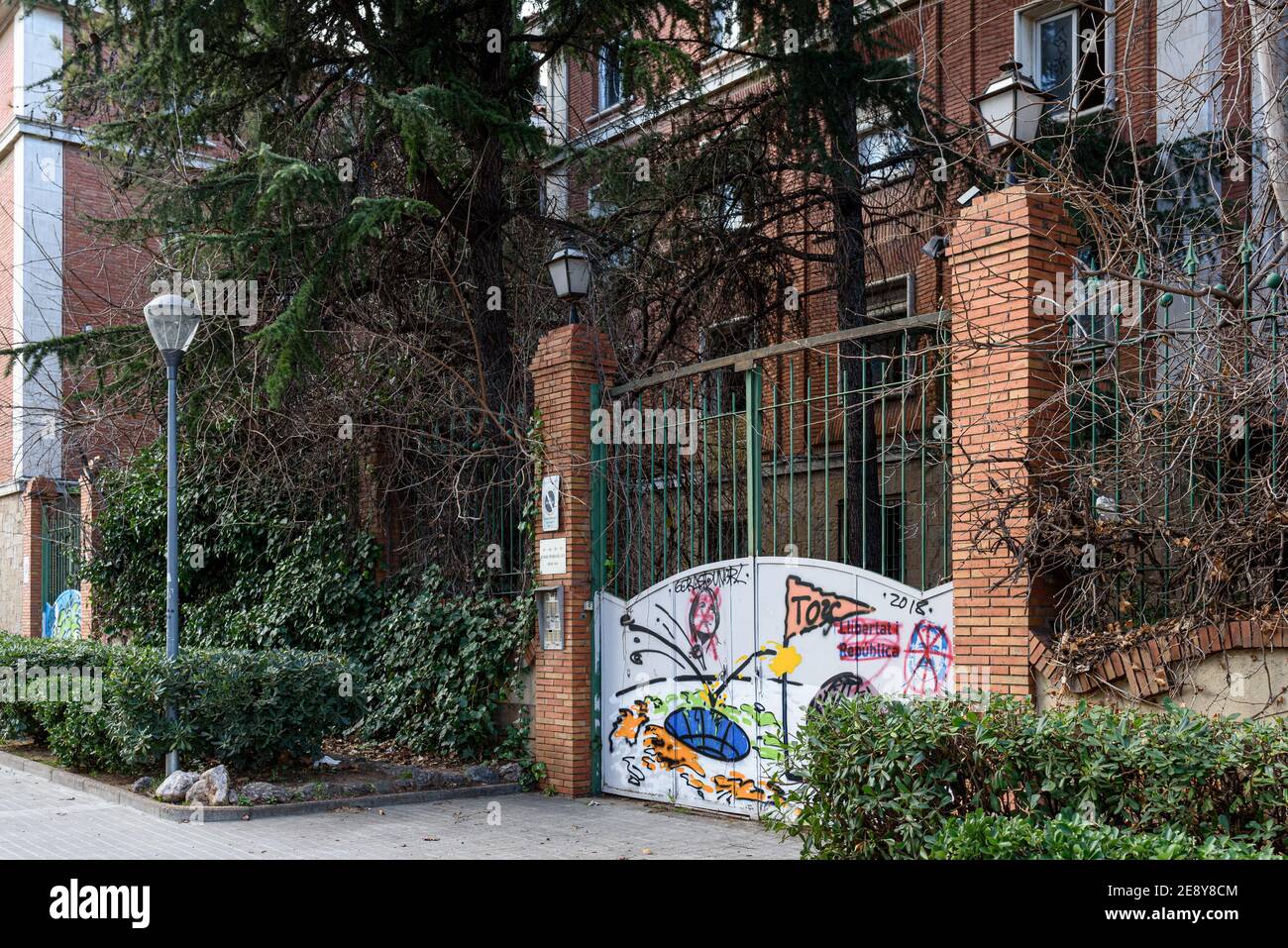Sabadell - Catalonia, SPAIN - January 31st of 2021: main entrance the old barracks of the Spanish civil guard closed and painted with graffiti Stock Photo