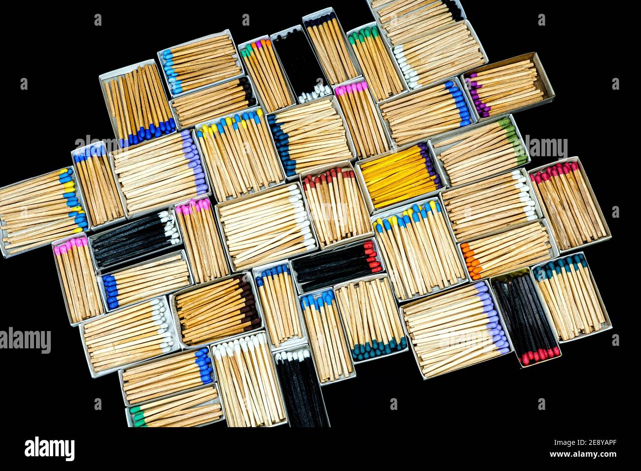multicolored match sticks in boxes on a black background Stock Photo
