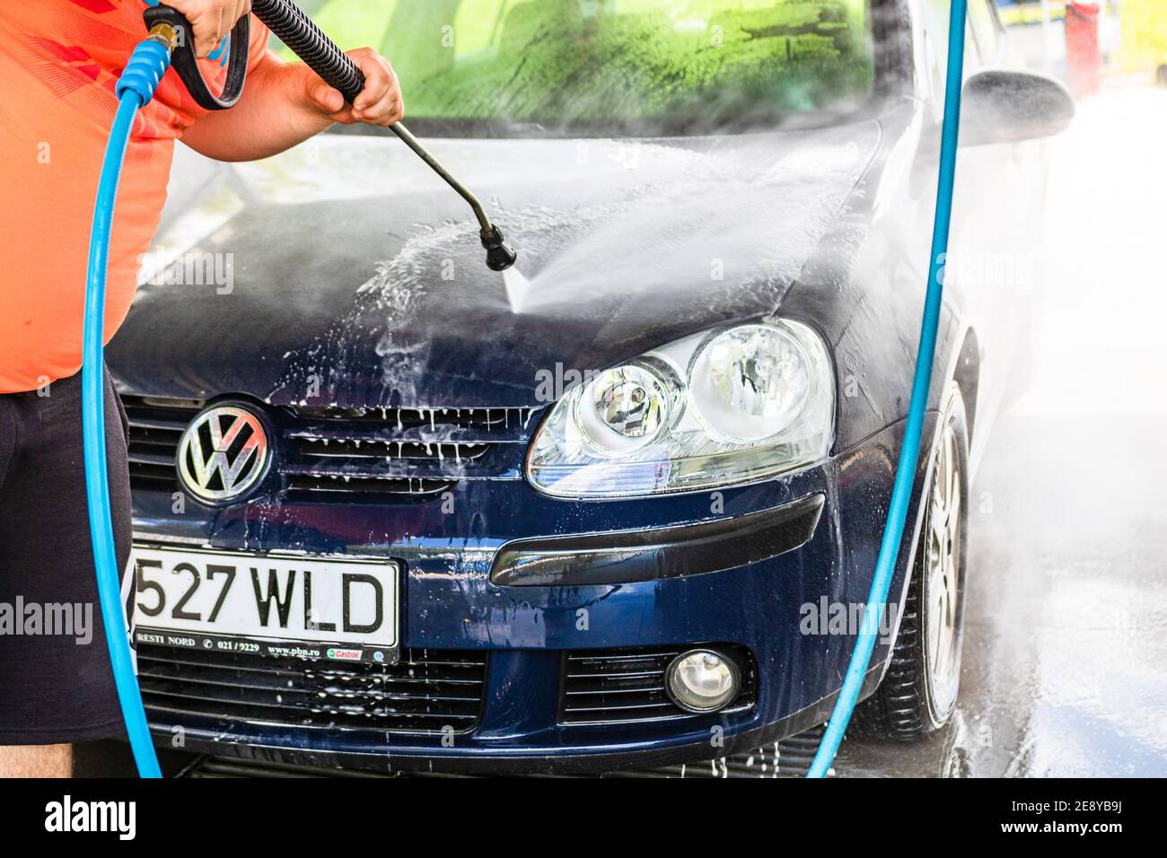 Washing and cleaning car in self service car wash station. Car washing