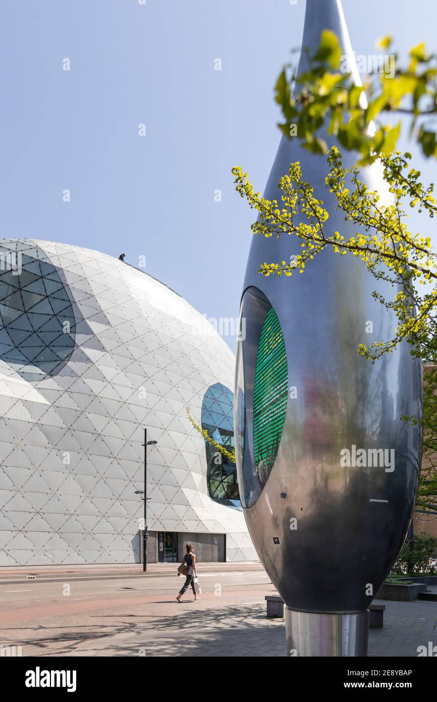 Eindhoven, The Netherlands, April 21st 2020. Exterior of the famous ’Blob’ building designed by Massimiliano Fuksas and a futuristic silver sculpture Stock Photo