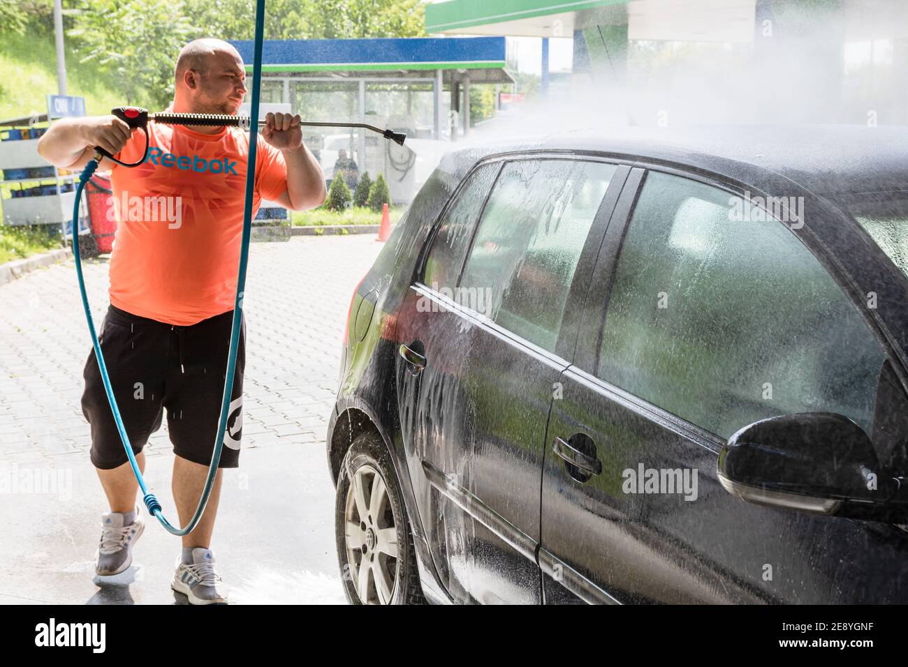 Washing and cleaning car in self service car wash station. Car washing