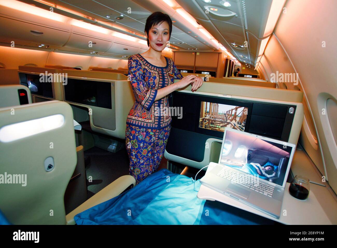 A Singapore Airlines stewardess in the business class section aboard the first Airbus A380, the world's largest passenger aircraft, as the delivery of it is made to Singapore Airlines following a ceremony at the Airbus delivery centre in Toulouse, France on October 15, 2007. Airbus claims the A380 offers a much quieter and more spacious cabin than its rivals. It can carry up to 853 passengers in an economy class-only configuration, but Singapore Airlines' A380's will have 471 seats. Photo by Pascal Parrot/ABACAPRESS.COM Stock Photo
