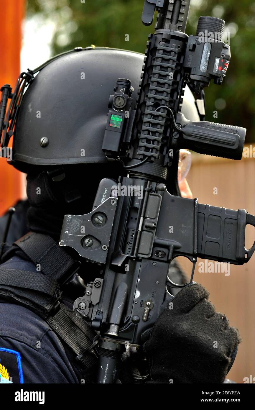 Police Tactical Response officers with a laser sighted automatic weapon. Stock Photo