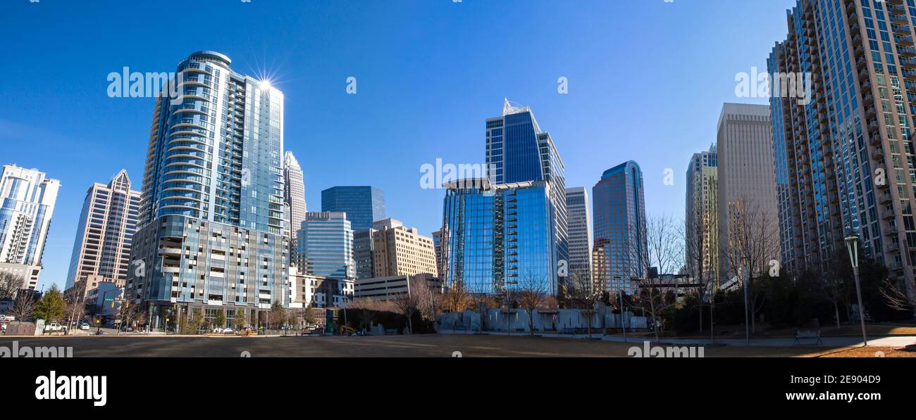 A panoramic view of the Charlotte, North Carolina, skyline in a bright blue sky as seen from Romare Bearden Park. Stock Photo