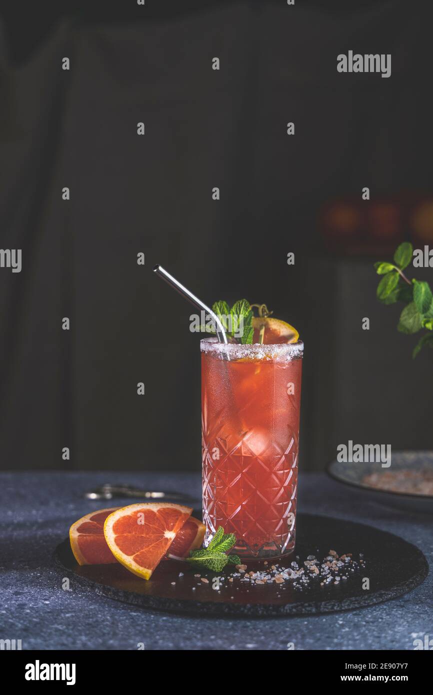 Pink Grapefruit Mezcal Paloma Cocktail in highball glass with water