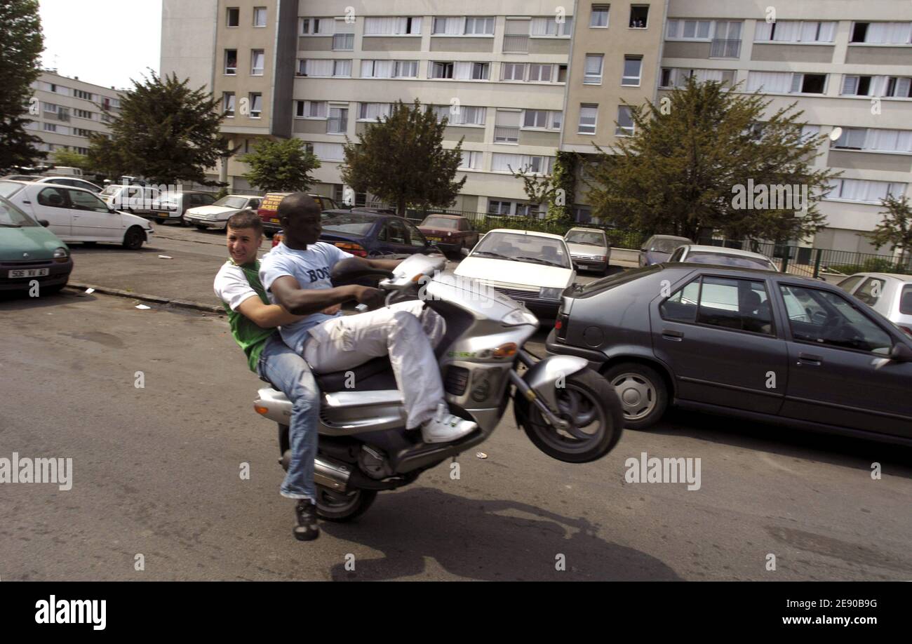 Youth of north suburb of Paris ride motocross and make wheelings along the  buildings in Bondy (93), France, on April 29, 2007. Motocross is a very  popular sport in Parisian suburbs. Photo
