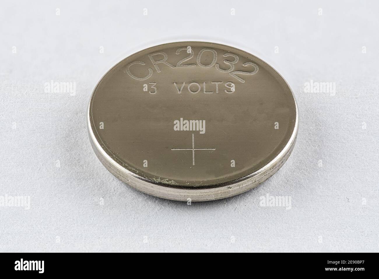 A CR2032 button cell lithium battery isolated Stock Photo