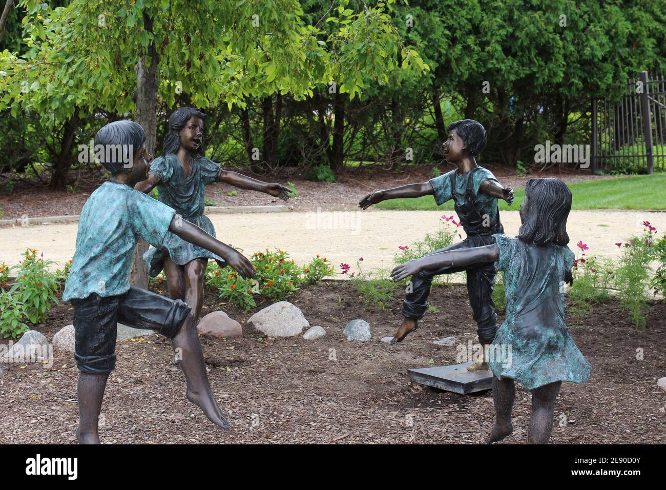 Bronze sculptures of four children playing in a circle at Rotary