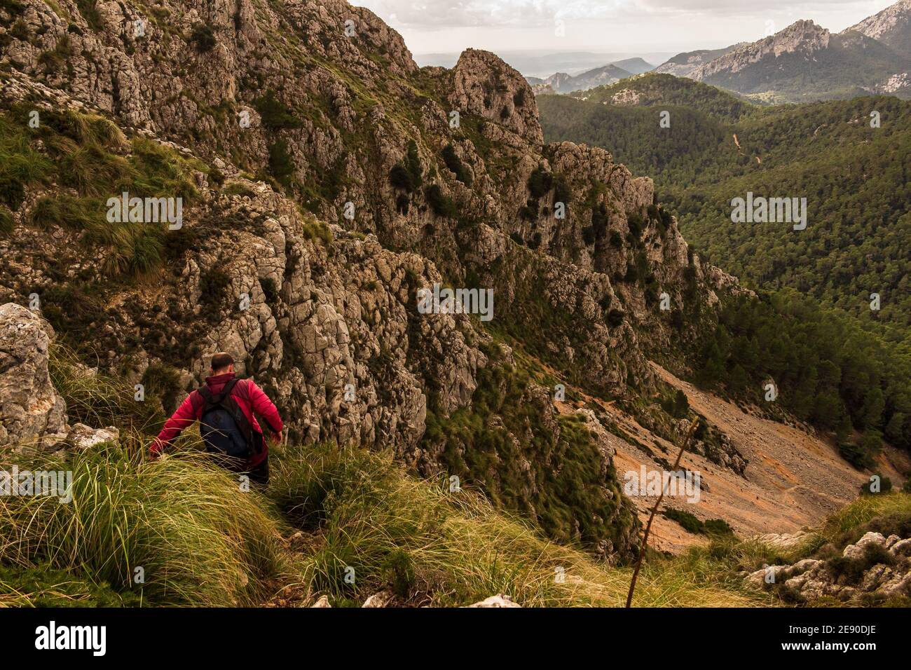 Trekker going down hill. Escorca. Serra de Tramuntana. Mallorca Island. Spain. Stock Photo