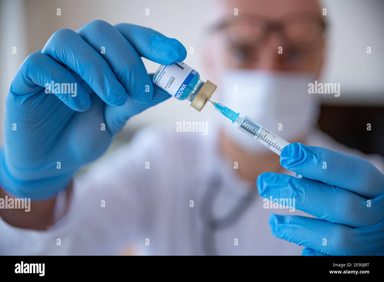 Doctor filling syringe with medication, closeup. Vaccination and