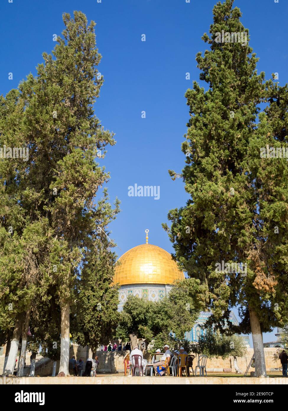 Muslim men talking under the trees by the Dome of the Rock in Temple Mount Stock Photo