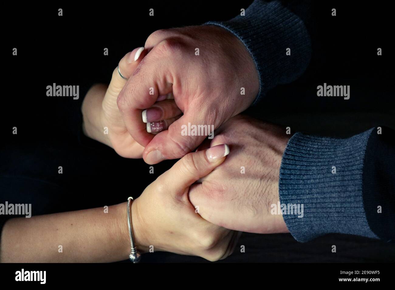 Male and female hands holding affectionately Stock Photo
