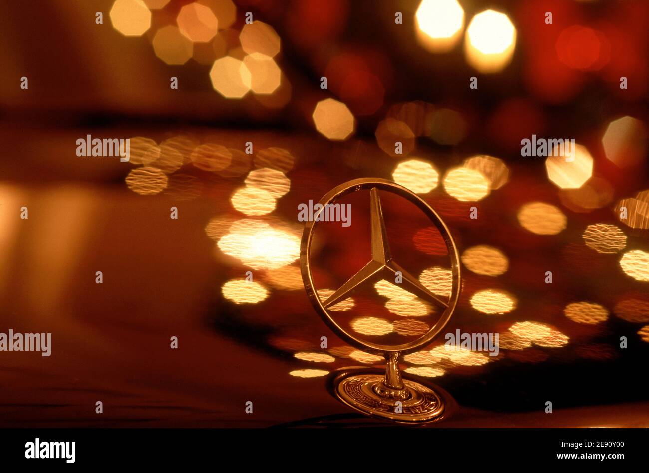 Mercedes Benz Star with city light reflextions at night . Stock Photo