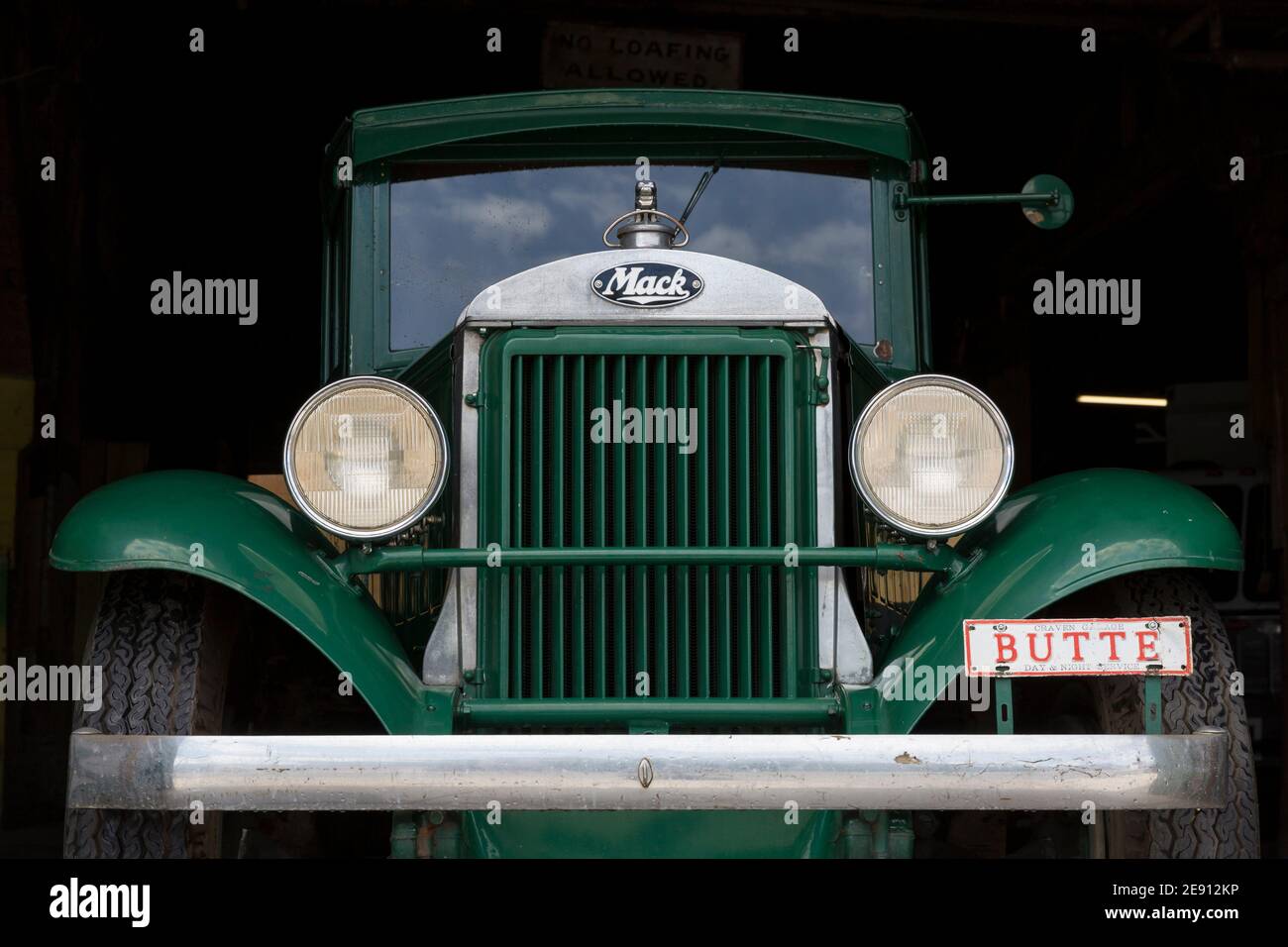 A classic Mack AB truck parked at a garage on Main Street in Butte, Montana. Stock Photo