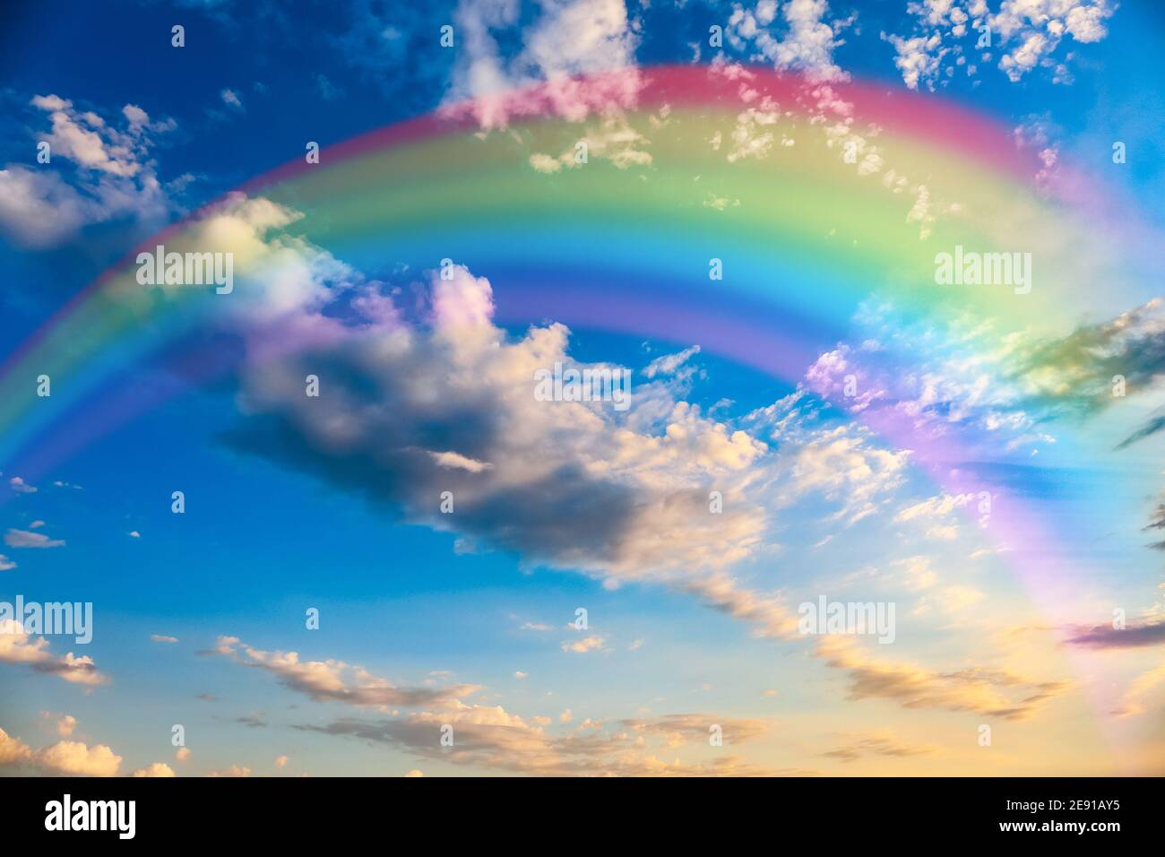 Beautiful view of blue sky with clouds and rainbow Stock Photo - Alamy