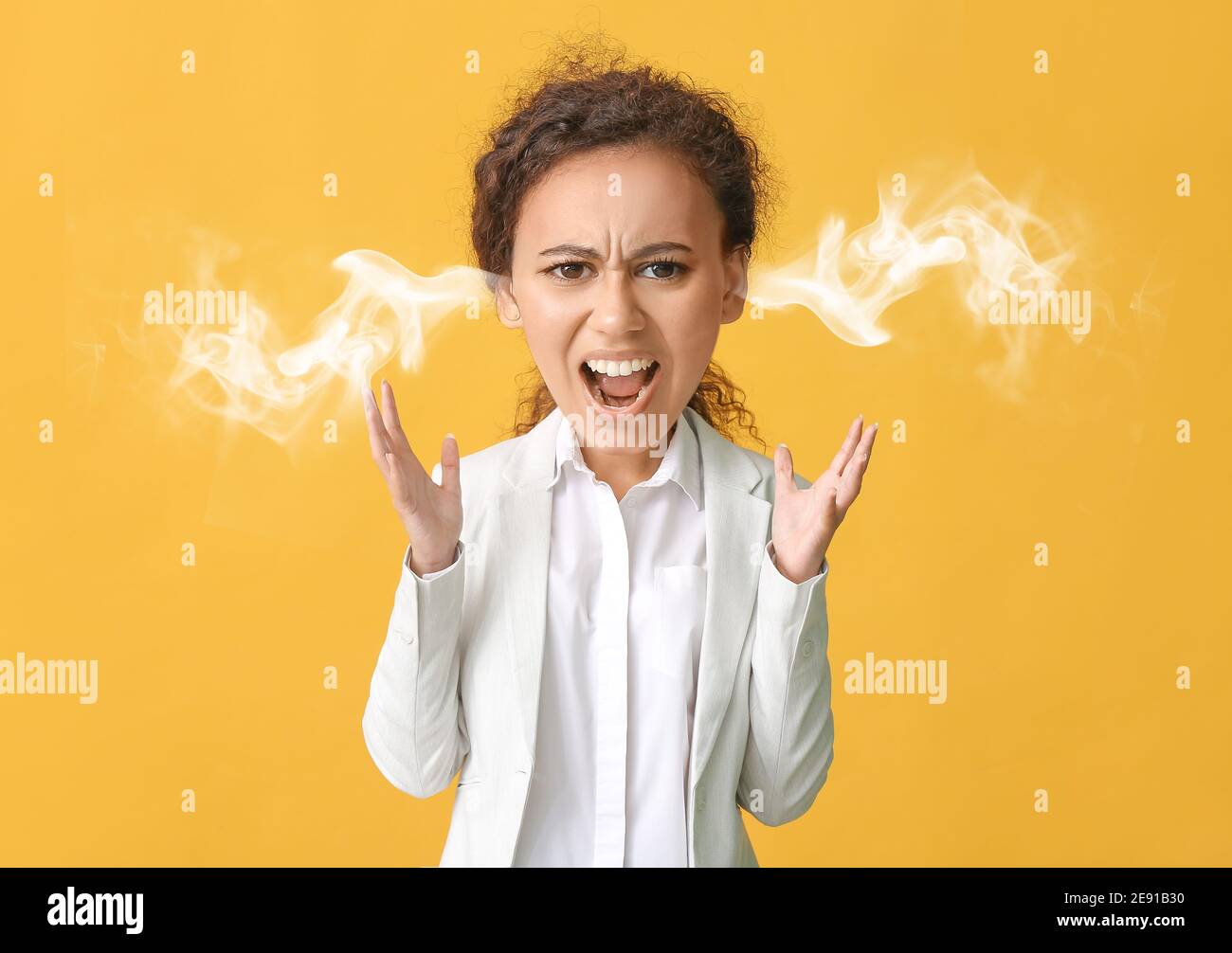 Angry African-American woman with steam coming out of ears on color background Stock Photo