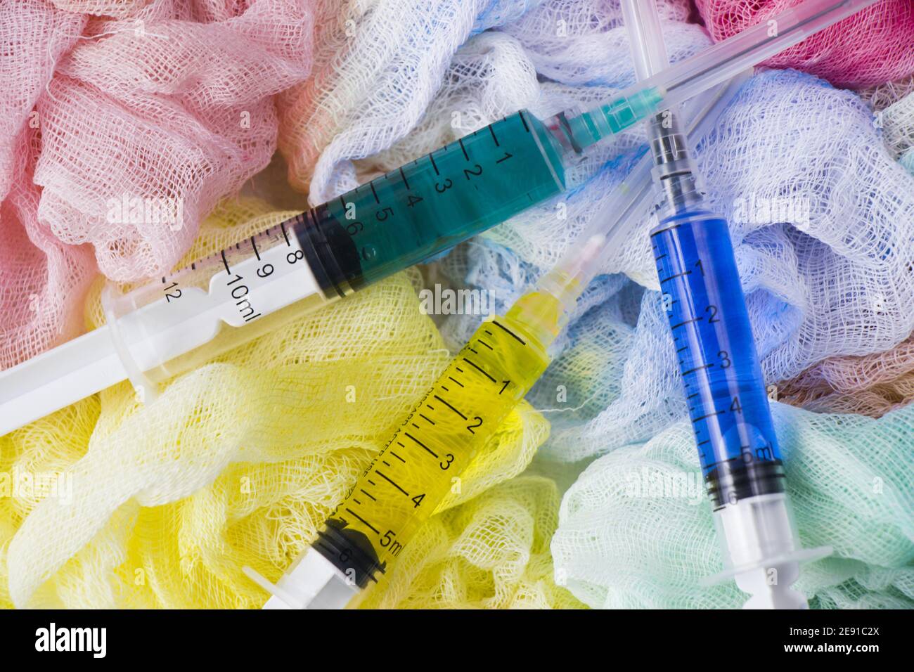 Top view of colored waters in the syringes on colored bandage background Stock Photo