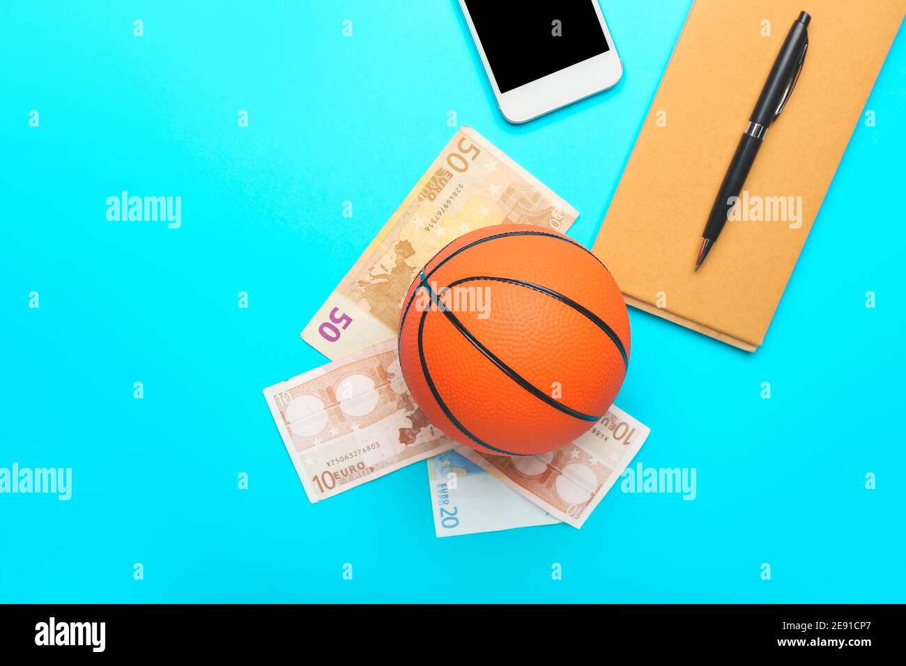 Money, ball for playing basketball and notebook on color background.  Concept of sports bet Stock Photo - Alamy