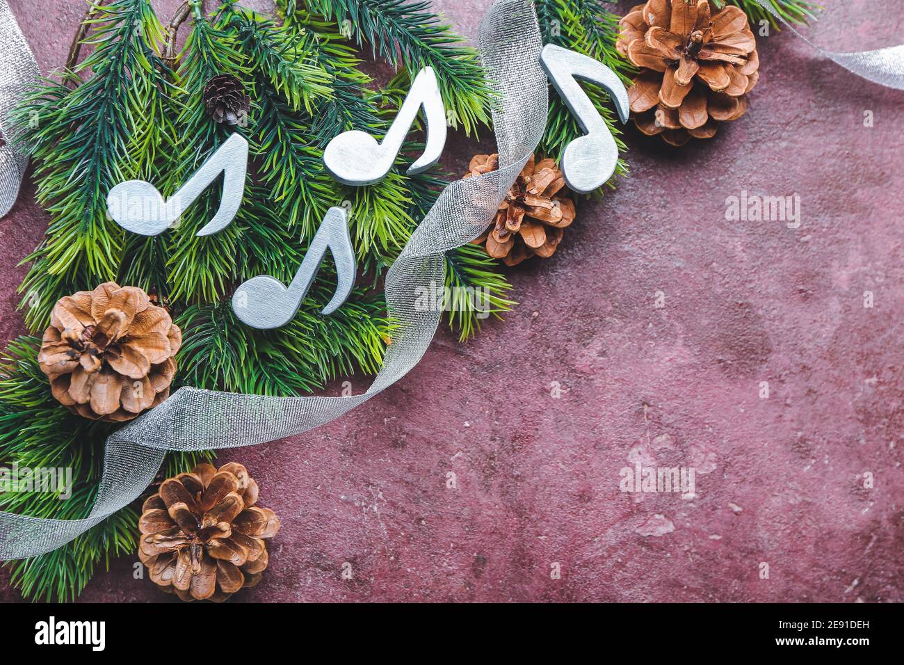Music notes with Christmas decor on color background Stock Photo - Alamy