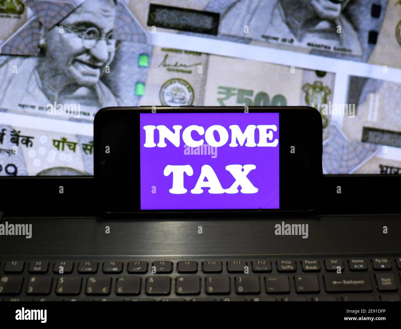 In this Photo illustration an Tax logo seen displayed on a