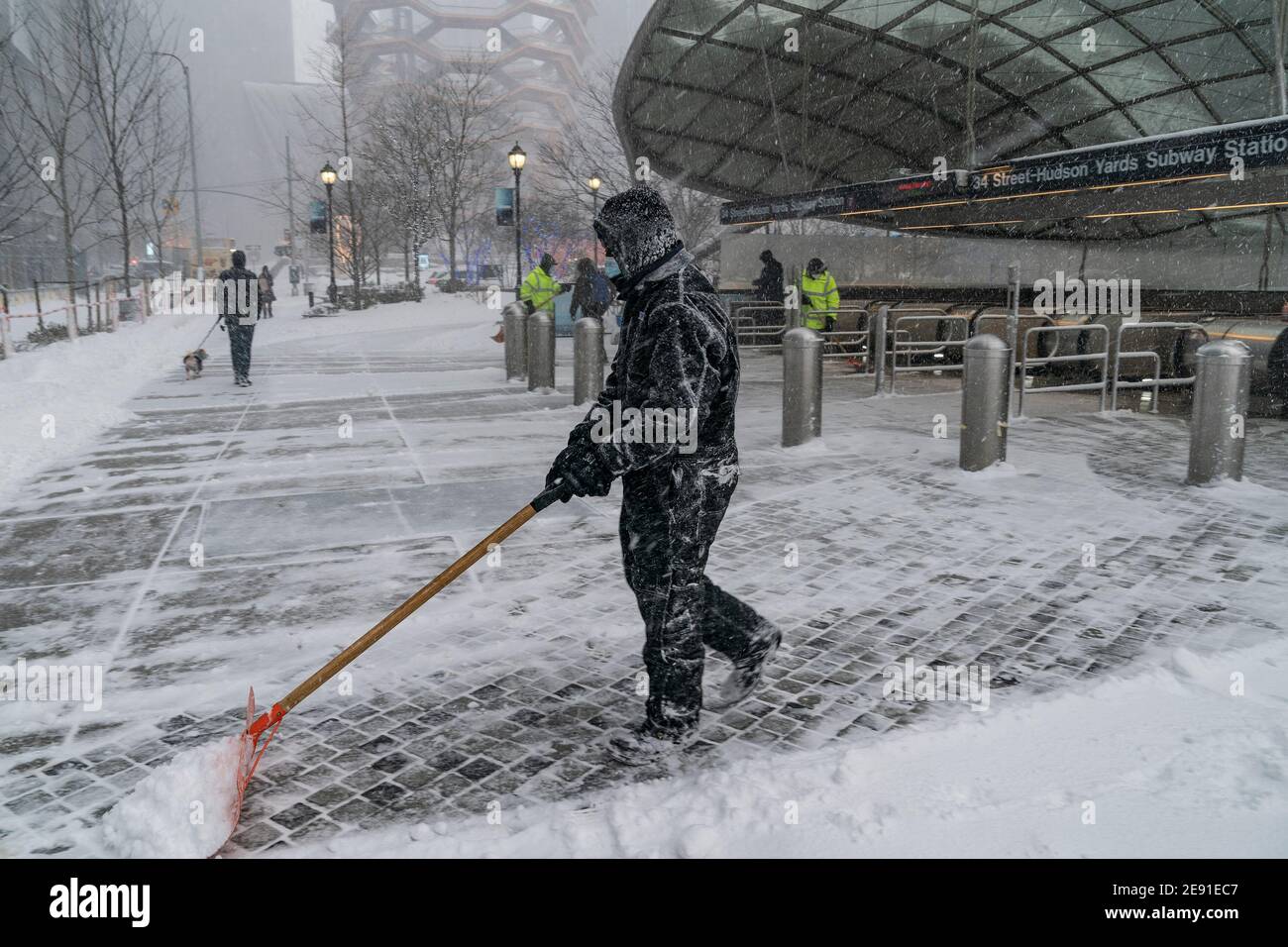 New York, United States. 01st Feb, 2021. Maintenance workers clear snow at Hudson Yards subway station entrance as major storm cover New York City with more than a foot expected on the ground on February 1, 2021. (Photo by Lev Radin/Sipa USA) Credit: Sipa USA/Alamy Live News Stock Photo