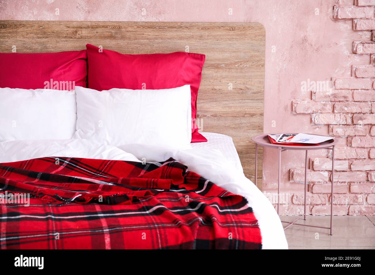 Comfortable bed near color wall Stock Photo Alamy