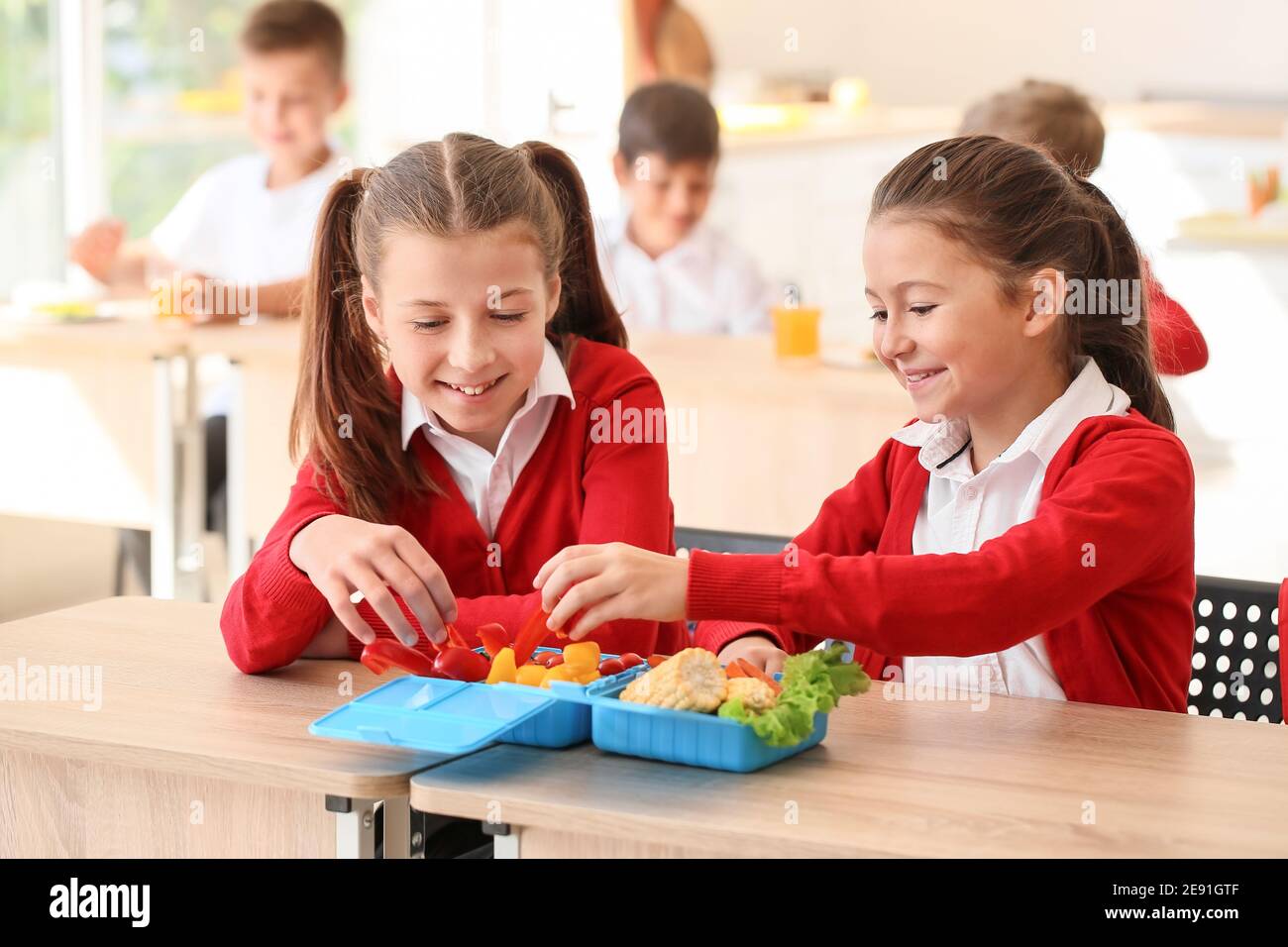 Pupils having healthy lunch in classroom Stock Photo - Alamy