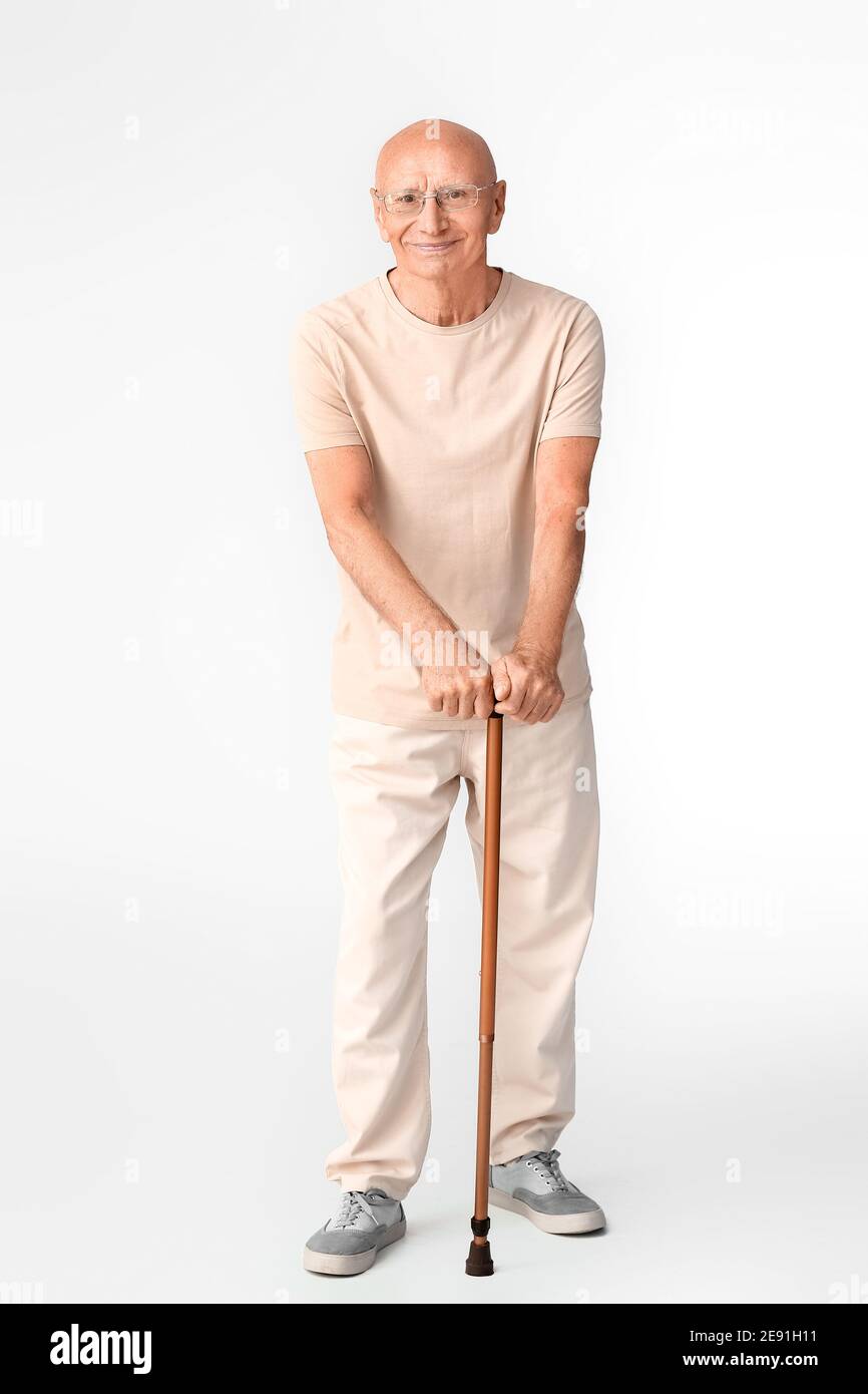 Senior man with walking stick on white background Stock Photo - Alamy