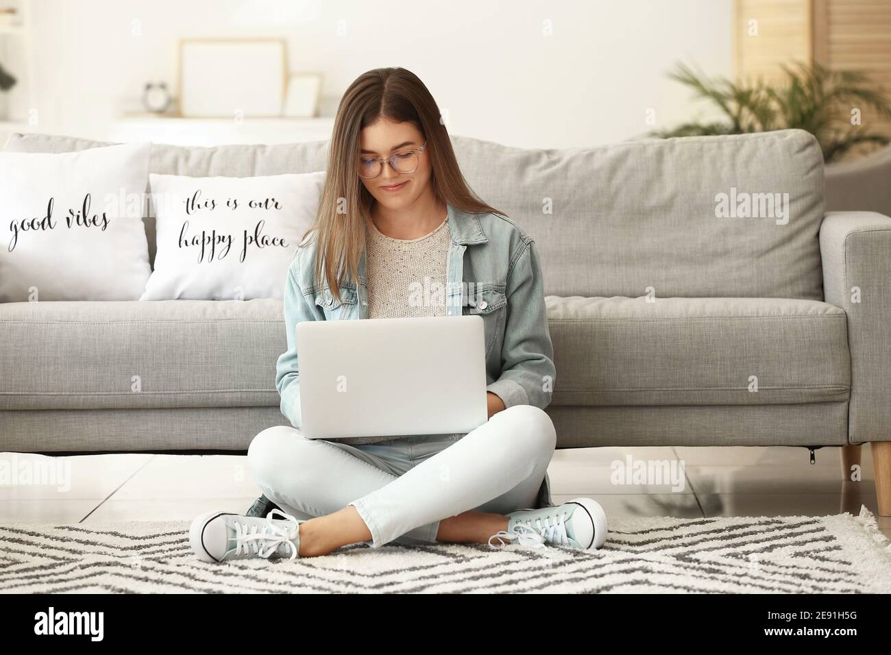 Beautiful young woman with laptop at home Stock Photo - Alamy