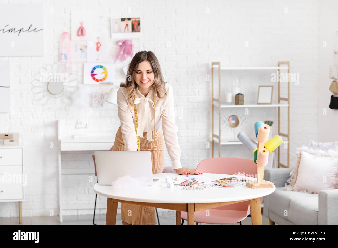 Female fashion designer working in studio Stock Photo - Alamy