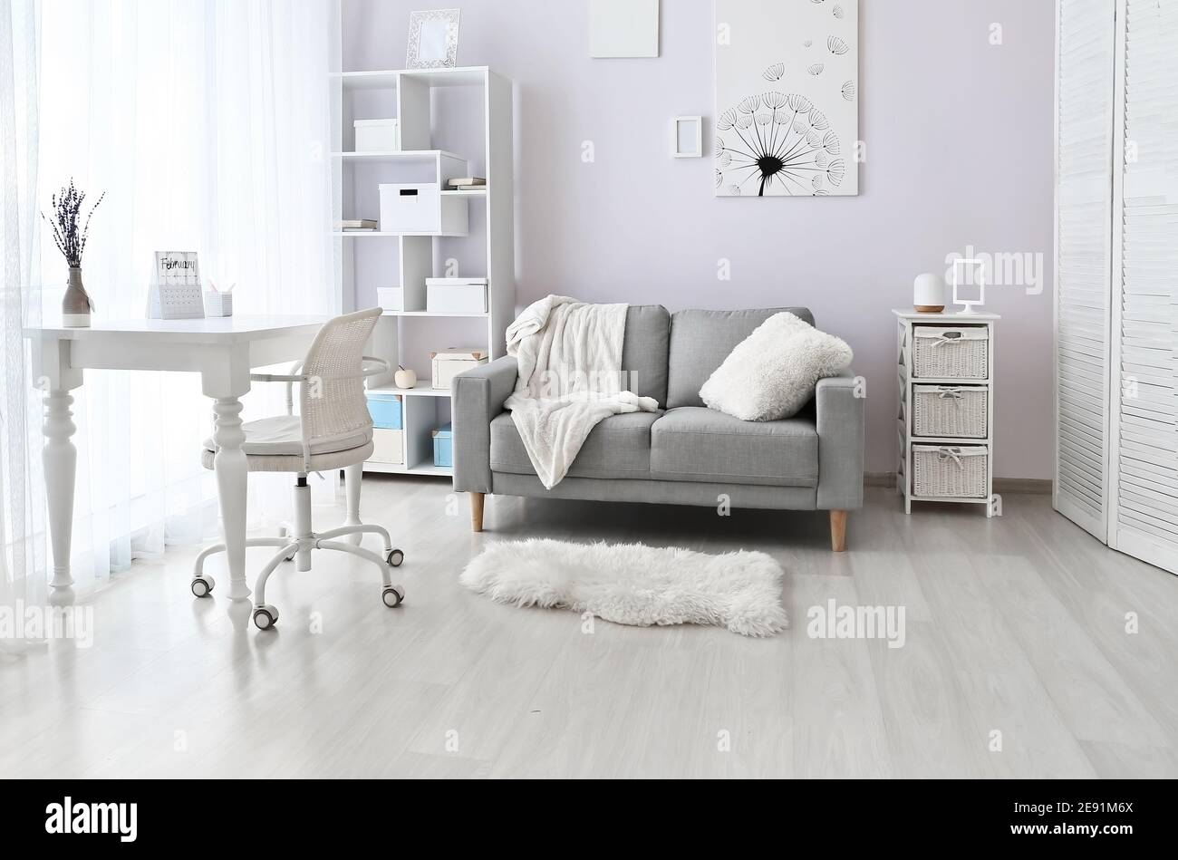 Stylish interior of living room with comfortable sofa Stock Photo - Alamy